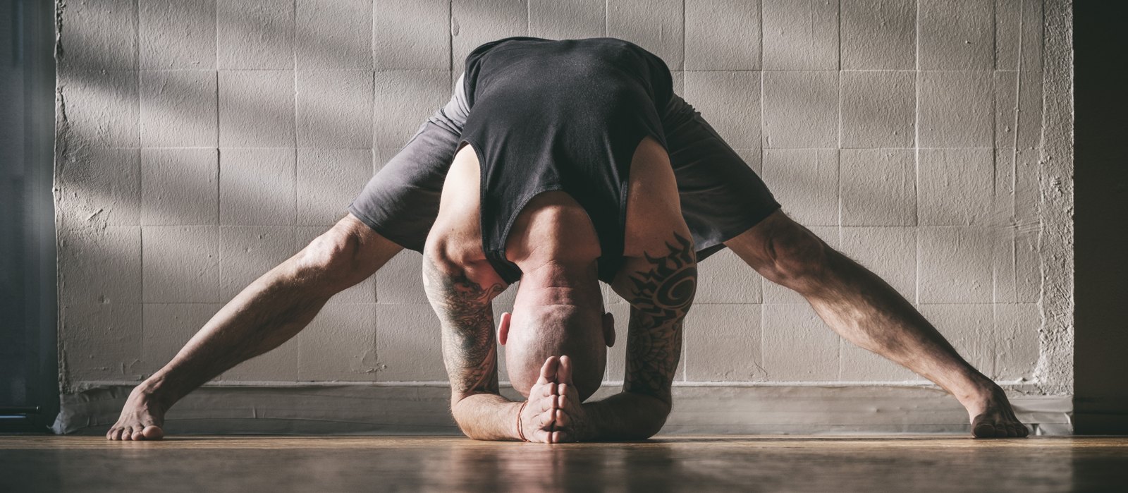 Andyji in a wide Prasarita Padottanasana